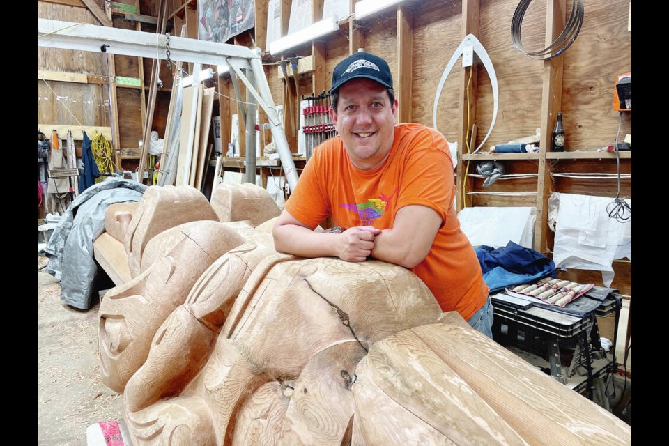 Multidisciplinary Indigenous artist Carey Newman, whose traditional name is Hayalthkingeme, pauses while working on a totem pole at his studio. Newman received an honorary doctor of laws degree at Royal Roads Universitys spring 2023 convocation on Friday, June 9. Via Royal Roads University 