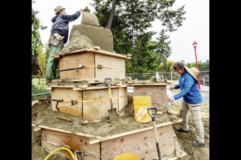 Damon Langlois, left, and Fred Dobbs work on the sand sculpture Mad Hatter's Tea Party for Sculpture Splash! Sand Castle Edition, which runs until Saturday at ­Esquimalt Gorge Park. An all-ages family picnic Tea Party will be held on ­Sunday, 1-3 p.m. at the park, 1070 Tilicum Rd. 	DARREN STONE, TIMES COLONIST 