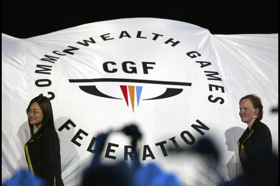 FILE - The Commonwealth Games Federation flag is carried into the arena during the Commonwealth Games opening ceremony in Melbourne, Australia on March 15, 2006. Australia's Victoria state Premier Daniel Andrews on Tuesday, July 18, 2023, said his government has withdrawn as host of the 2026 Commonwealth Games because of a massive increase in the projected cost of staging the multi-sports event. (AP Photo/Mark Baker, File)