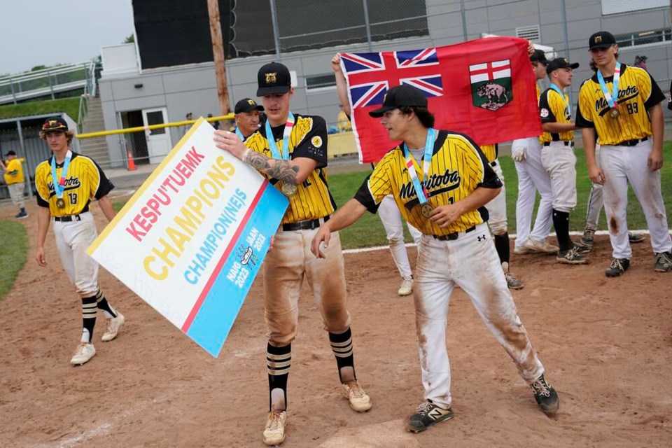 Cody Gunderson of Team Manitoba holds a championship sign in the Mi’kmaq, English, and French languages following Team Manitoba’s win over Team Wisconsin in the gold medal game of U19 Baseball at the North American Indigenous Games 2023 in Halifax on Friday, July 21, 2023. THE CANADIAN PRESS/Darren Calabrese 