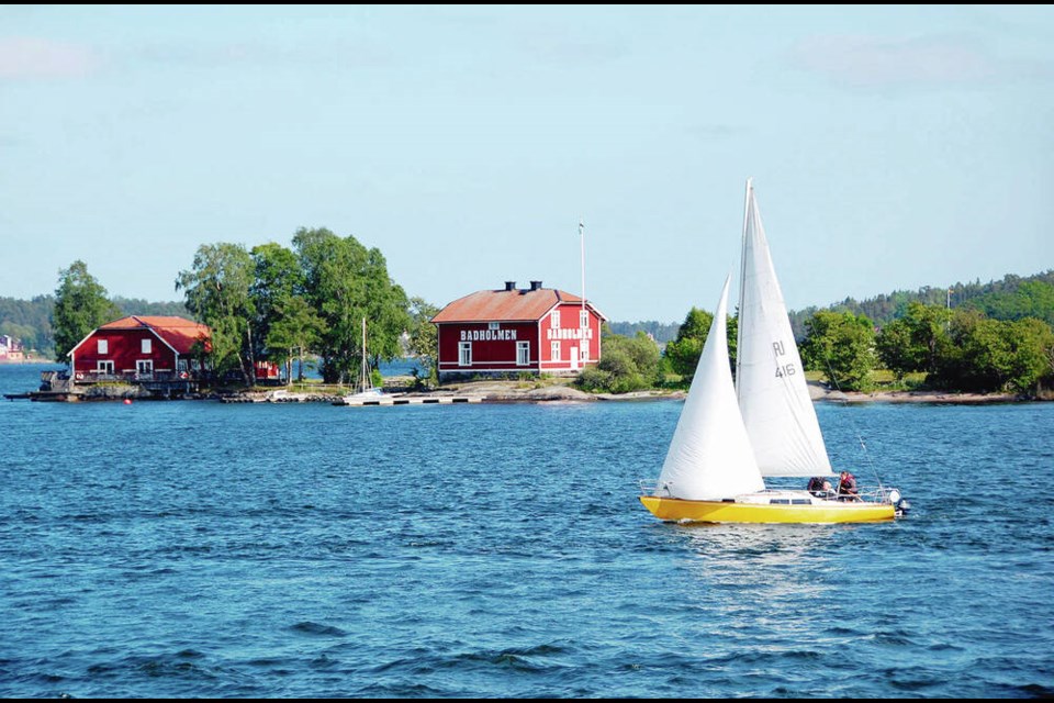 A sailboat zips by one of the tiny granite islands in Stockholm’s archipelago. Cameron Hewitt 