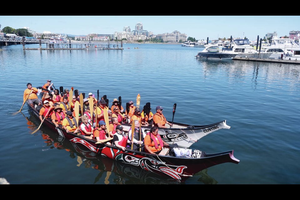 Dignitaries from Songhees Nation, Esquimalt Nation, the City of Victoria, event sponsors and the RCMP arriving in the TL'Ches Spirit Canoe and the Salish Seawolf Canoe in Victoria's Inner Harbour for a canoe ceremony on Canada Day.    TIMES COLONIST