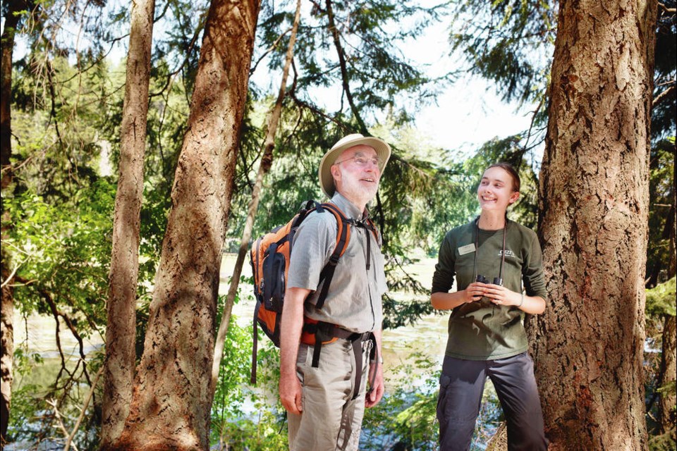 CRD Parks naturalist Emma-Jane Vignola with a park visitor. All 33 of the CRD's regional parks were added to the Canadian Protected and Conserved Areas Database this year. VIA CRD Parks 