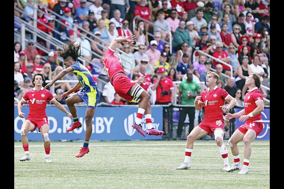 saʴý’s Elias Hancock, centre, and Barbados’ Mikyle Walcott go up for the ball.  