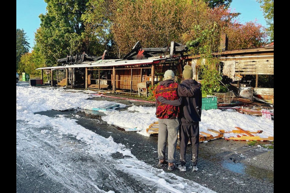 Sabrina Anderson, left, and Whirly Bird, who had recently leased the building, survey the fire damage. VIA STRAY MOAT FARM MARKET 