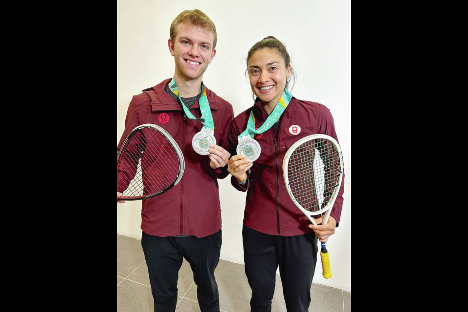 Nicole Bunyan of Victoria and partner George Crowne show off their silver medals from the mixed doubles squash event at the Pan Am Games in Santiago, Chile, on Friday. SQUASH CANADA 