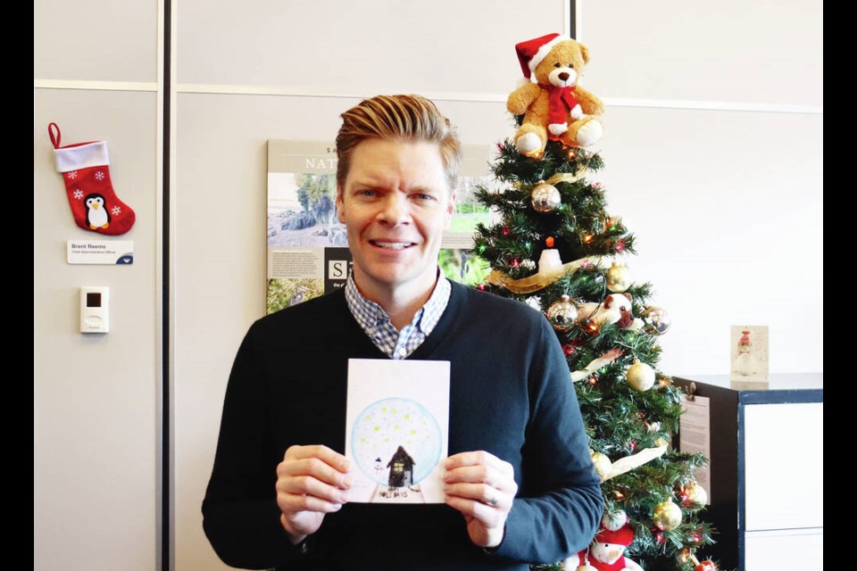 Saanich Mayor Dean Murdock holds the holiday card featuring the winning design. VIA DISTRICT OF SAANICH 