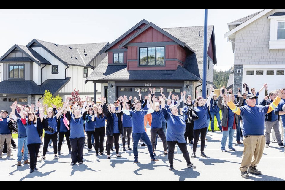 Westhills Land Corp. workers pose for a group photo to celebrate the construction of Westhills 1,000th home in Langford. DARREN STONE, TIMES COLONIST 