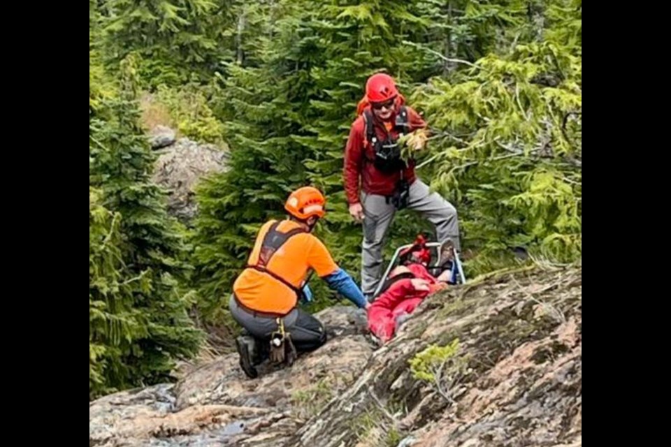 Comox Valley Search and Rescue Team members load an injured Victoria man onto a stretcher at Century Sam Lake. VIA COMOX VALLEY SEARCH AND RESCUE 