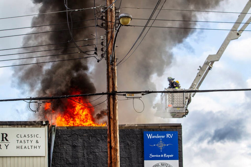 Firefighters battle a fire at Rising Star Wholesale Bakery in Esquimalt on Wednesday, May 22, 2024. Esquimalt Fire Rescue Chief Matt Furlot said the fire rising from the bakery’s roof looked “pretty dramatic.” DARREN STONE, TIMES COLONIST 