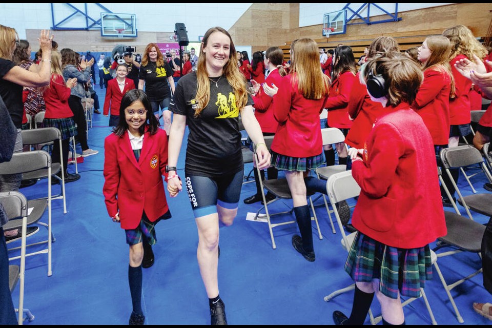 saʴý reporter Roxanne Egan-Elliott with Grade 3 student Sophie Sharma at the Cops for Cancer Tour de Rock’s annual kick-off event at St. Margaret’s School on Friday. DARREN STONE, TIMES COLONIST 