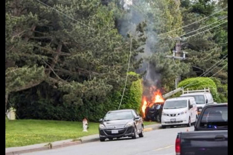 A vehicle hit a utility pole on East Saanch Road on Monday night and caught fire. The collision left utility lines dangling, and knocked out power for neighbourhood into Tuesday. MICHELE SEALEY 