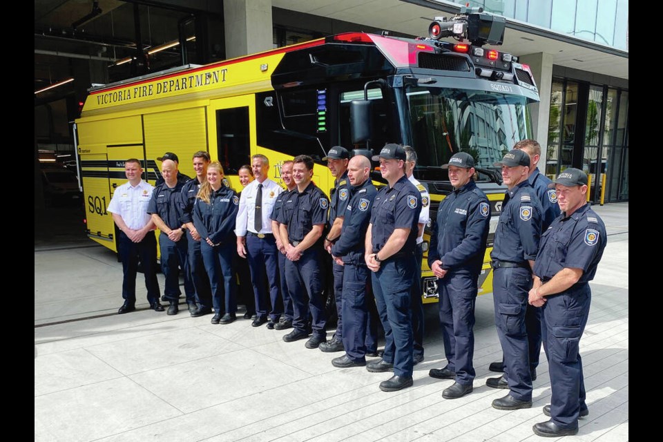 Friday morning’s shift at the Victoria Fire Department with the new electric fire truck. Fire Chief Dan Atkinson is in the white shirt and tie.	TIMES COLONIST 