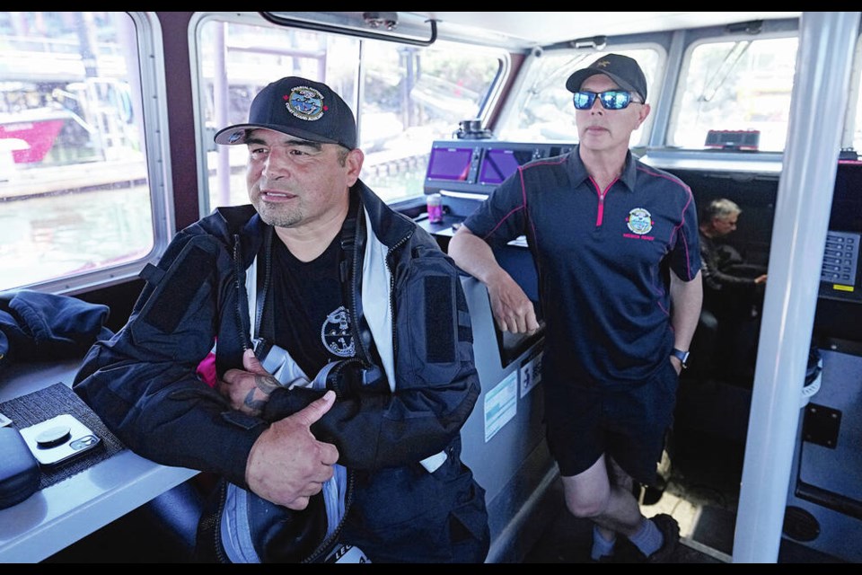 Kurt John, left, from Ahousaht and Harry Alfred from Alert Bay aboard a Coastal Nations Coast Guard Auxiliary vessel during a skills demonstration this past week at the James Bay coast guard base. ADRIAN LAM, TIMES COLONIST 