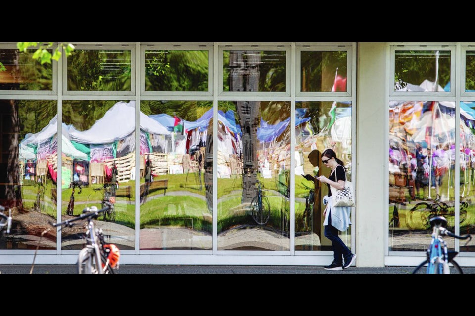 The Palestine Solidarity Encampment is reflected in the windows of the McPherson Library on the University of Victoria campus. DARREN STONE, TIMES COLONIST 
