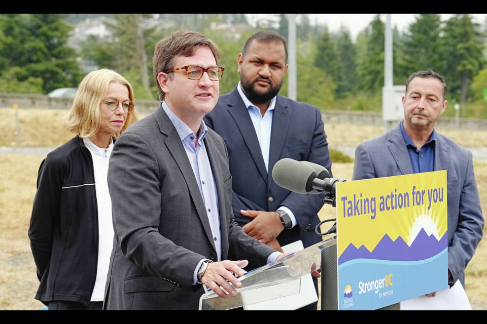 Transportation Minister Rob Fleming announces bus-lane improvements, on Monday. With him are Mitzi Dean, MLA for Esquimalt-Metchosin, left, Ravi ­Parmar, MLA for Langford-Juan de Fuca, and Aaron Lamb, B.C. Transit VP of asset management and chief sustainability officer, ADRIAN LAM, TIMES COLONIST 