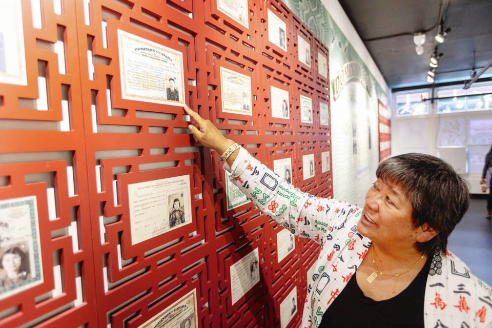 Charlayne Thornton-Joe points to her grandfather Chow Sun’s head tax certificate (her grandmother Annie Chow is right below) at the Chinese Canadian Museum after the launch of their new exhibition, “Victoria in the Time of Exclusion” which explores the intergenerational impacts of the Chinese Immigration Act of 1923 (also known as Chinese Exclusion Act) through the lens of families and individuals living in Victoria during 1923-1947. DARREN STONE TIMES COLONIST 