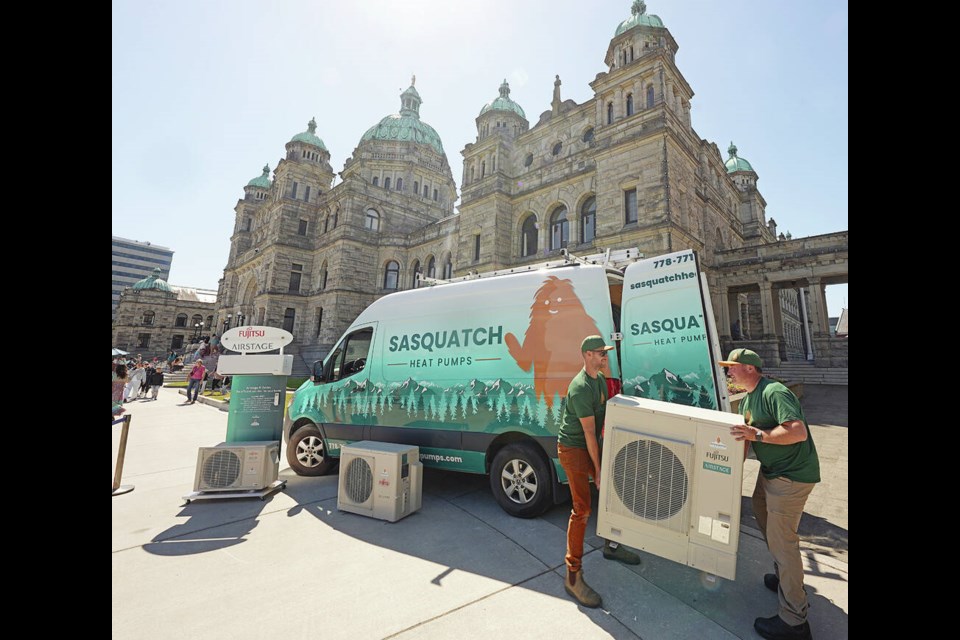 Dale Morton, left, and Kevin Olson from Sasquatch Heat Pumps set up Wednesday at the legislature prior to Josie Osborne, minister of Energy, Mines and Low Carbon Innovation, announcing B.C.’s expanded heat-pump program. ADRIAN LAM, TIMES COLONIST 