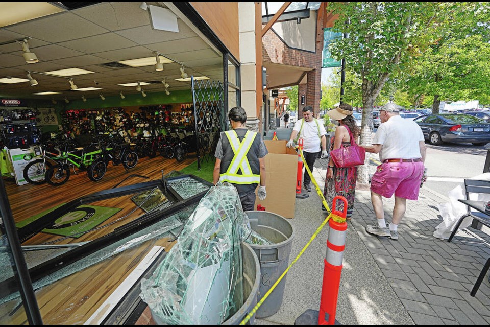 Crews clean up after a dramatic break-in involving a forklift at the Ride the Glide e-bike store in Broadmead Village. ADRIAN LAM, TIMES COLONIST 