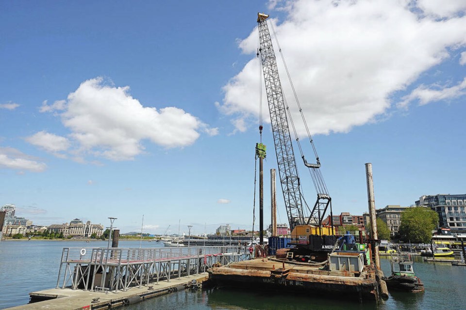 Crews work on dismantling the former V2V ferry dock in the Inner Harbour on Tuesday. ADRIAN LAM, TIMES COLONIST 