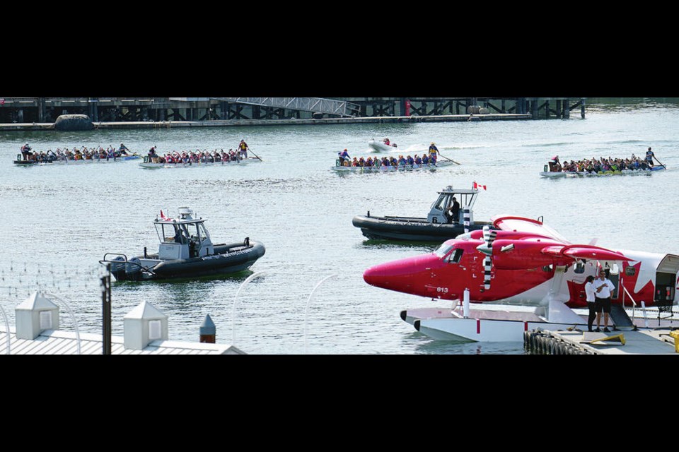 Victoria Harbour was a busy place on Saturday with dragon boats mixing with the regular traffic.   ADRIAN LAM, TIMES COLONIST