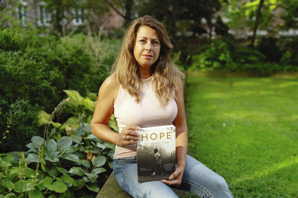 Barbara Adhiya with a copy of her book "Hope by Terry Fox," in Toronto this week. PAIGE TAYLOR WHITE, THE CANADIAN PRESS 