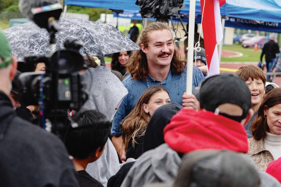 Olympic gold-medallist Ethan Katzberg carries the 91ԭ flag at a celebration in Nanaimo. CITY OF NANAIMO 