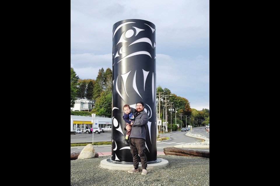 Artist Jesse Recalma in front of the new art installation at the Qualicum Beach waterfront improvement project. TOWN OF QUALICUM BEACH 