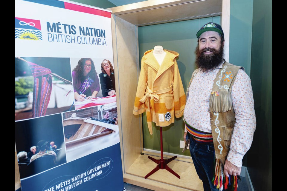 Patrick Harriott shows a Métis capote, or capot, a long wrap-style wool coat with a hood at the Point Ellice House trading post area. DARREN STONE, TIMES COLONIST 