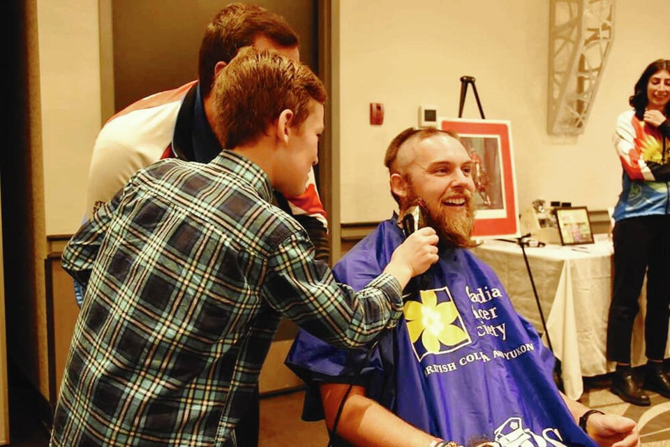 Owen Wetklo helps out with shaving Tour de Rock rider Nicholas Arnold of Vista Radio Sun FM on Sunday in Nanaimo. TOUR DE ROCK 