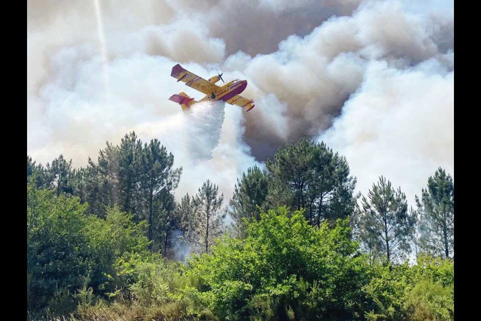 A French fire brigade uses a Canadair plane for fighting a wildfire near La Teste-de-Buch, southwestern France, on 
July 16, 2022. European countries are buying nearly two dozen De Havilland Canadair firefighting planes. SDIS 33 VIA AP 