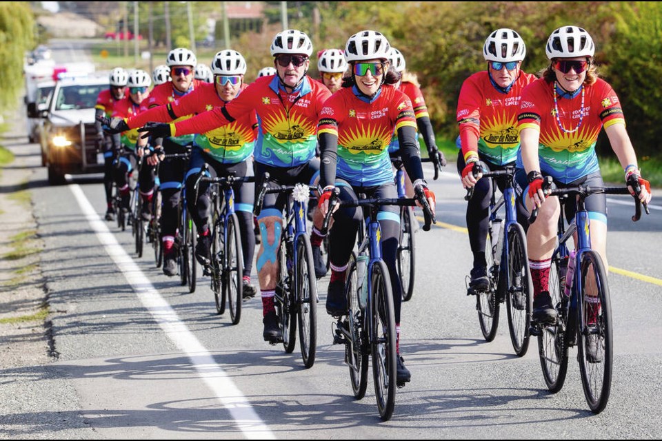 Times Colonist reporter Roxanne Egan-Elliott, right, and Bailey Parker of Virgin Radio lead the pack as the Cops for Cancer Tour de Rock travels on Keating Cross Road on Thursday. The cycling tour is raising money for pediatric cancer research. Donate at tourderock.ca. DARREN STONE, TIMES COLONIST 