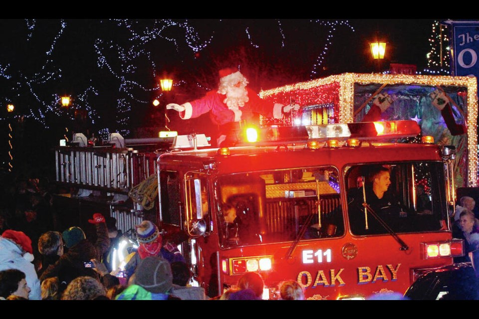 Santa arrives in Oak Bay Village on a fire truck during a past Oak Bay Light Up. This year’s event starts at 2 p.m. today and features live music and family-oriented activities, with Santa Claus and Mrs. Claus set to arrive on an Oak Bay fire truck after the ceremonial plugging in at 5 p.m. of the lights  which will stay up until Jan. 6. ADRIAN LAM, TIMES COLONIST 