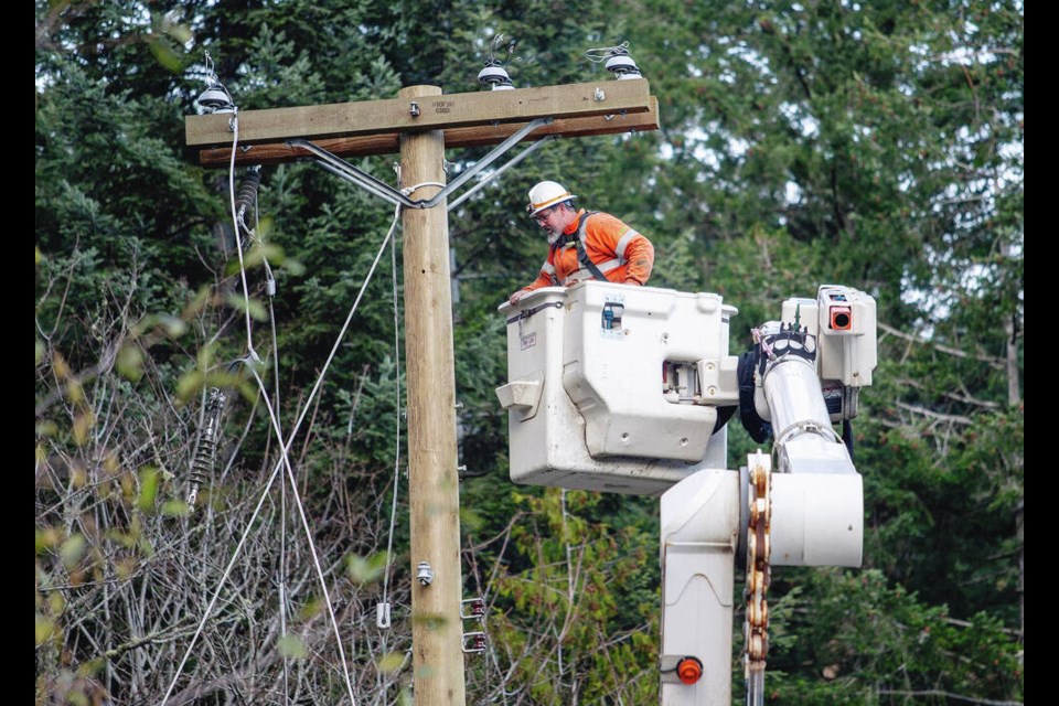 B.C. Hydro crews work to restore power on Sooke Road near Gillespie Road after the “bomb cyclone.” DARREN STONE, TIMES COLONIST 