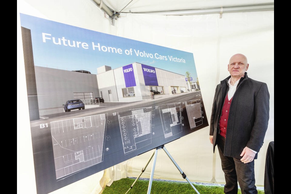 Peter Trzewik, chief operating officer for GAIN Group of Companies, with artwork for the new Volvo Cars Victoria dealership location at 2512 Government Street. 
DARREN STONE, TIMES COLONIST 