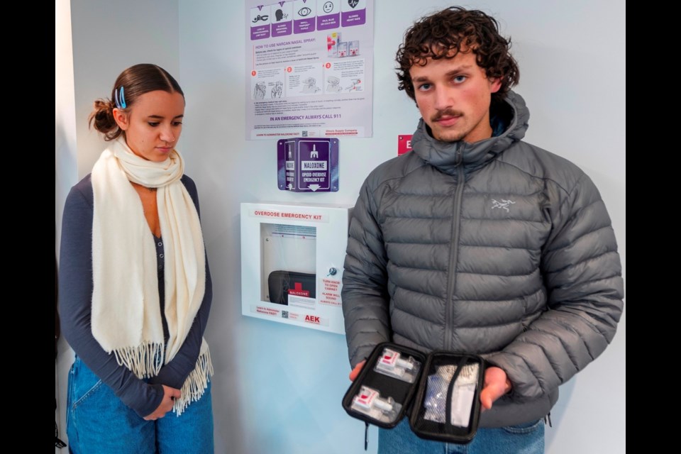 Adrianna Balic, left, and Zachariah Fenniri with naloxone kits in the UVic student residence. DARREN STONE, TIMES COLONIST 