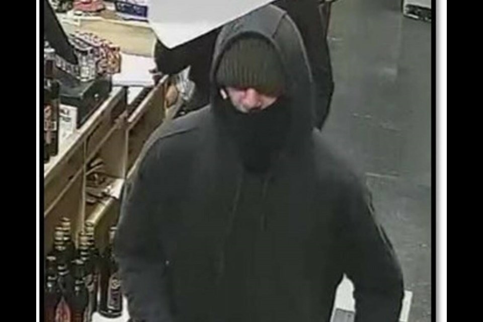 Police described the robber as five-foot-10 with a medium build, and wearing a black hoodie, a dark-coloured tuque and khaki pants with grey socks covering his hands. VIA NANAIMO RCMP 