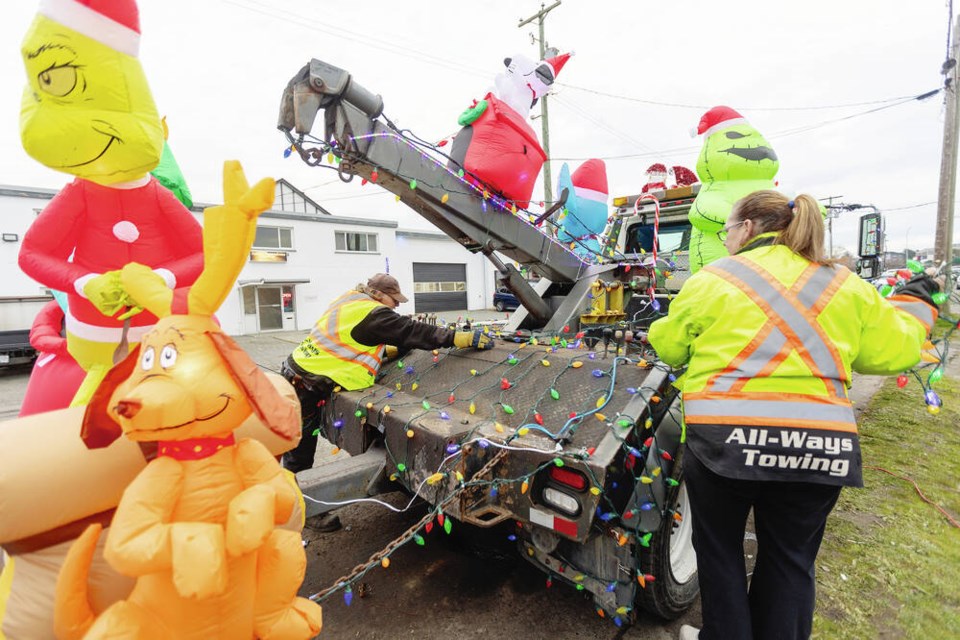 All-Ways Towing owners Gary Parker and Cheryl Parker prepare their truck for the IEOA Truck Parade & Food Drive through Greater 
Victoria on Saturday. DARREN STONE, TIMES COLONIST 