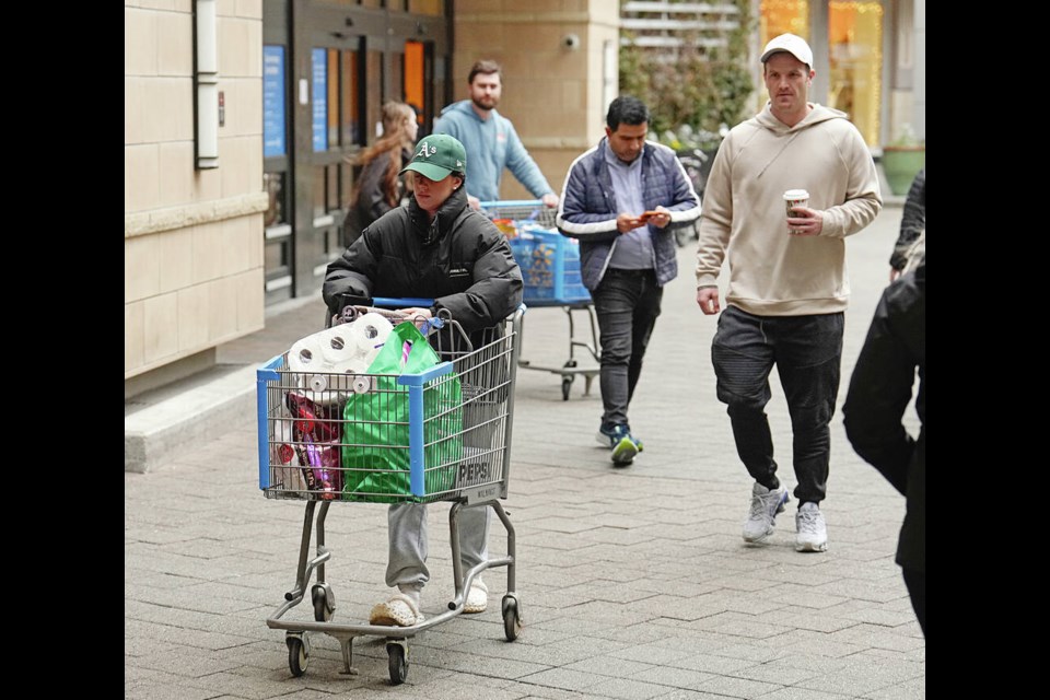 Shoppers leave Walmart at Uptown on Friday. Starting Saturday, the federal government is waiving the five per cent federal goods and services tax (GST) on a number of products, including children’s clothing, books, toys, restaurant meals, newspapers, food and some alcohol for two months. ADRIAN LAM, TIMES COLONIST. 