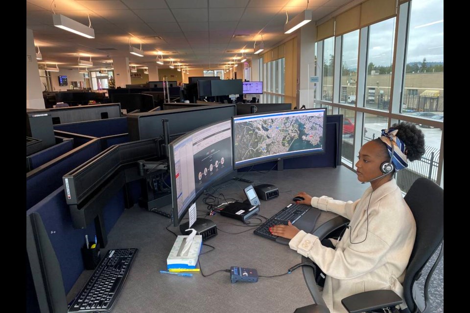 Kuzi Mujakachi takes calls at the E-Comm Communications Centre in Saanich. She has handled up to 60 calls on a 12-hour shift. TIMES COLONIST 