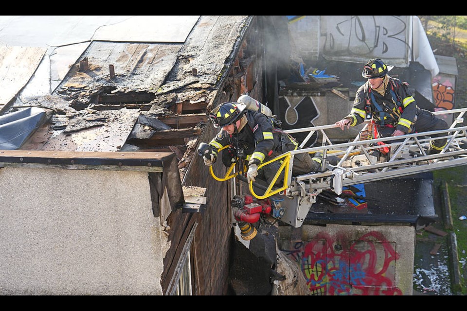 Victoria firefighters check for hot spots at the Turner Building on Richmond Avenue Wednesday morning. ADRIAN LAM, TIMES COLONIST 