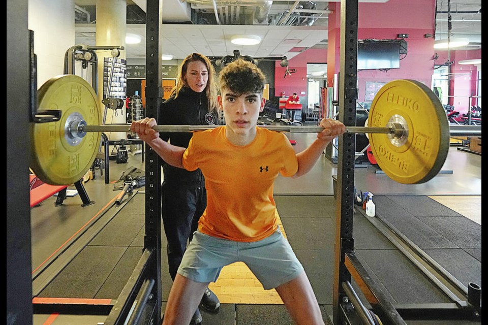 Instructor Lindsay Lynk helps Levi Powell run a drill of squats, as Canadian Sport School students train at PISE at the University of Victoria this week. The Pacific Institute for Sport Education, or PISE, has started a campaign to raise $500,000 for its Gift of Play and Gift of Potential programs, which aim to give children and youth of all abilities and circumstances equal opportunity to be involved in physical activities. ADRIAN LAM, TIMES COLONIST 