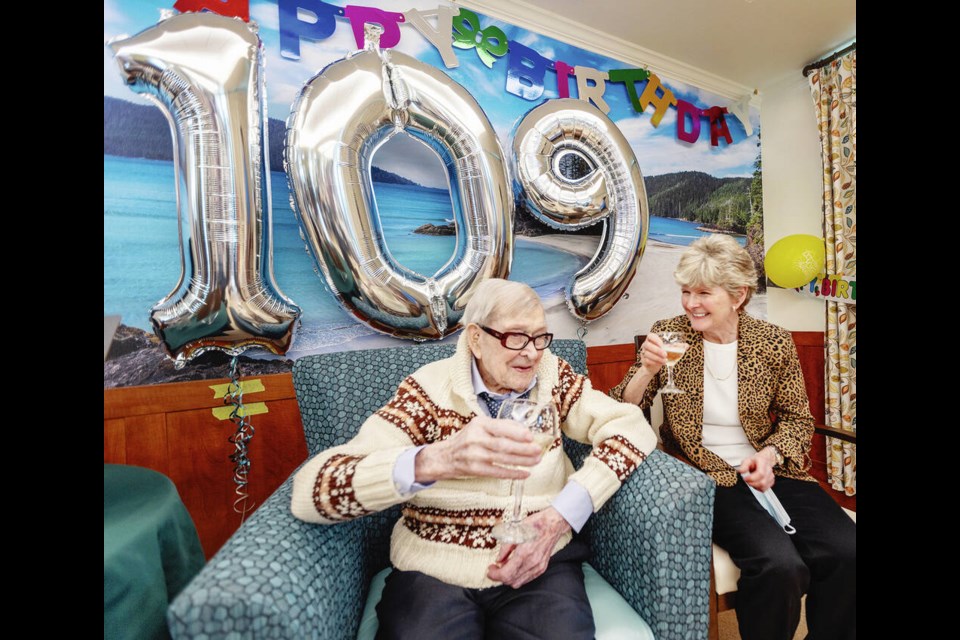 Albert Middleton and daughter Darlene Van Raay drink champagne at his 109th birthday party at Broadmead Care’s Veterans Memorial Lodge last March. DARREN STONE, TIMES COLONIST  